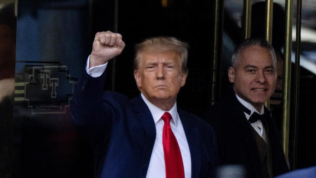 Former President Donald Trump raises a fist as he leaves Trump Tower to face criminal charges in New York City on April 4, 2023.