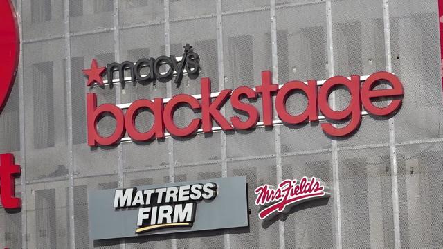 A sign for Macy's Backstage at the Queens Place Mall. 