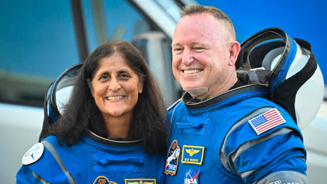 NASA astronauts Suni Williams, left, and Butch Wilmore, wearing Boeing spacesuits, depart the Neil A. Armstrong Operations and Checkout Building at Kennedy Space Center in Florida on June 5, 2024.