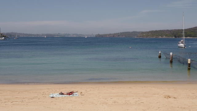 A lone sunbather sits on the beach during the morning sunshine at Manly on Nov. 26, 2024, in Sydney, Australia.