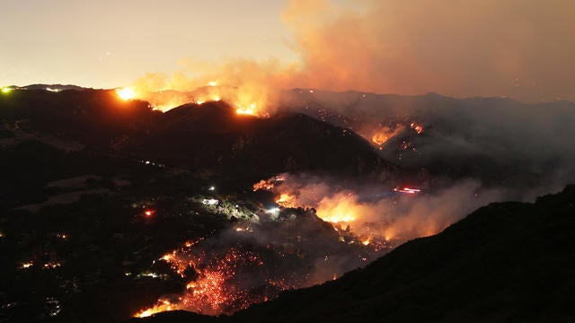 Flames and smoke from the Palisades Fire surround a home in the community of Topanga, California, on Jan. 9, 2025. 