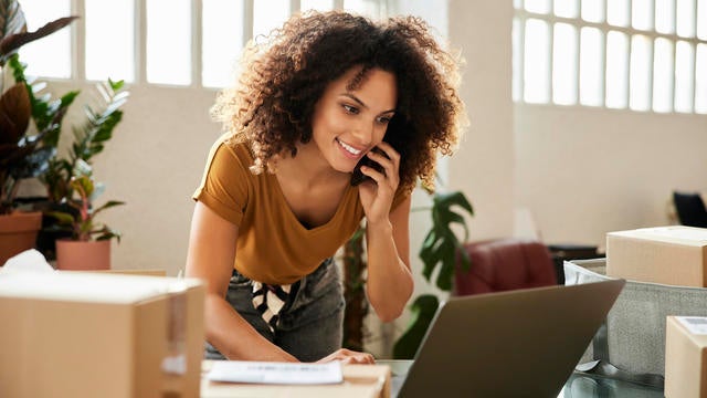 Entrepreneur Using Laptop At Home Office 